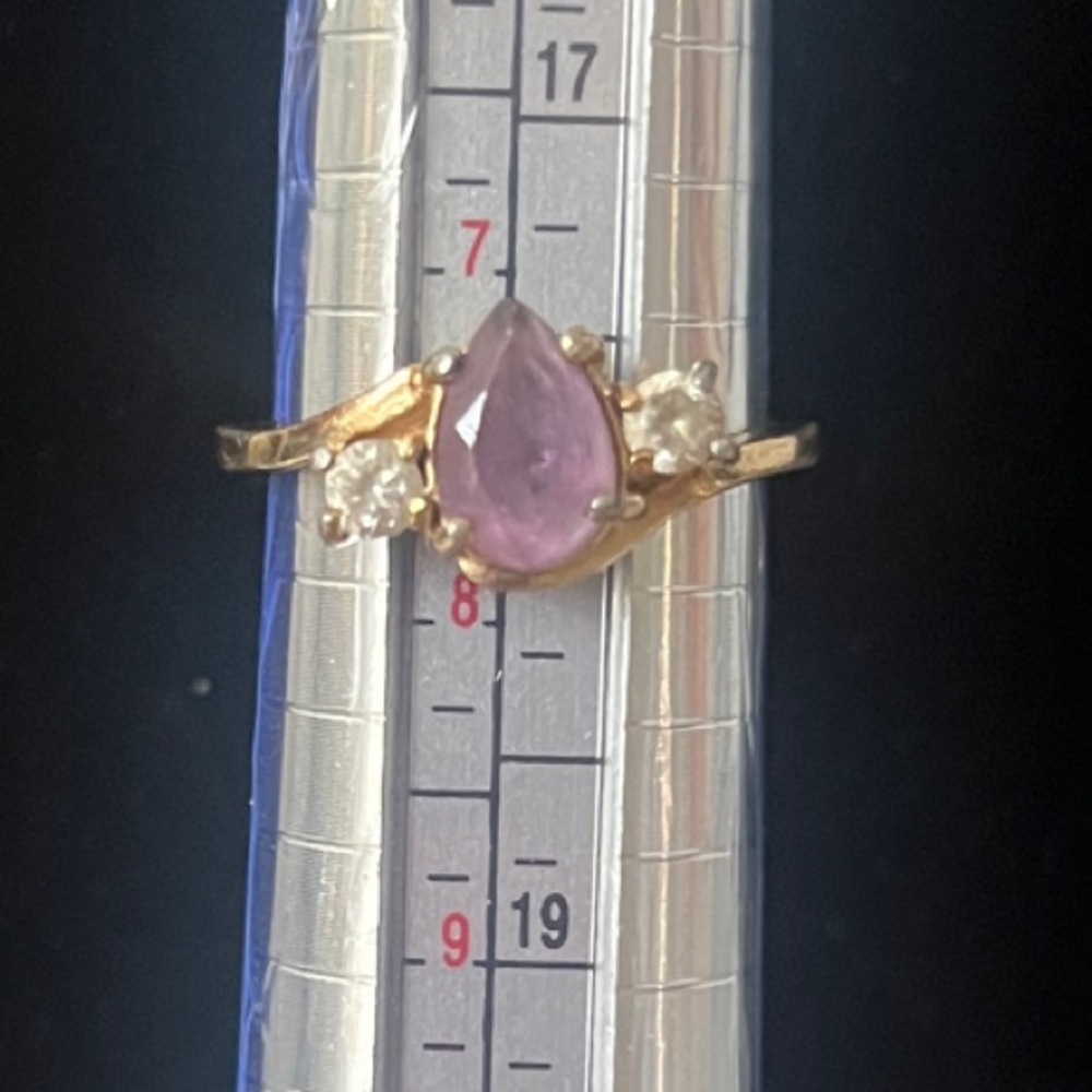 Gold Ring with Purple Pear Shaped Stone Flanked by 2 CZ